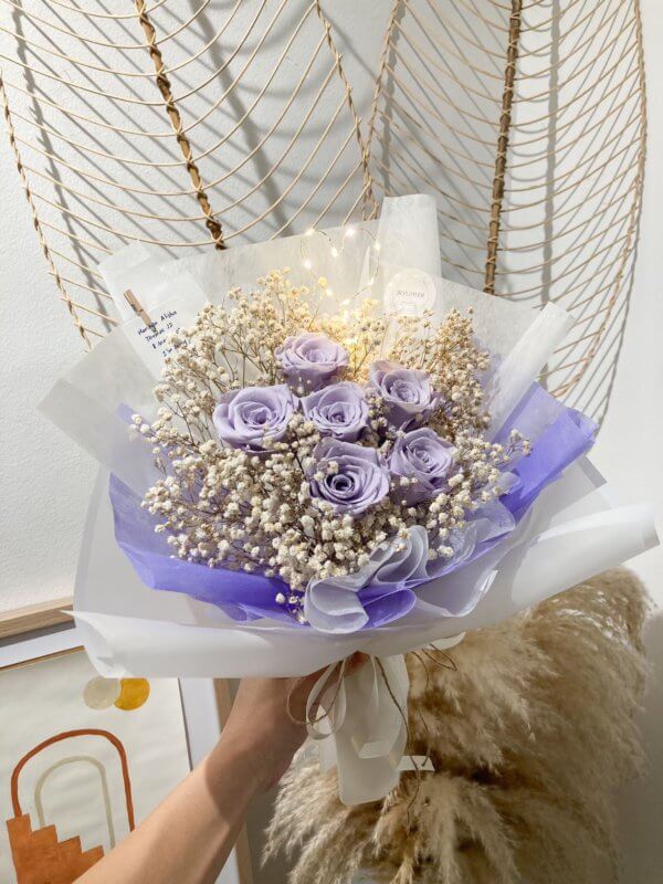 purple roses with baby breath bouquet