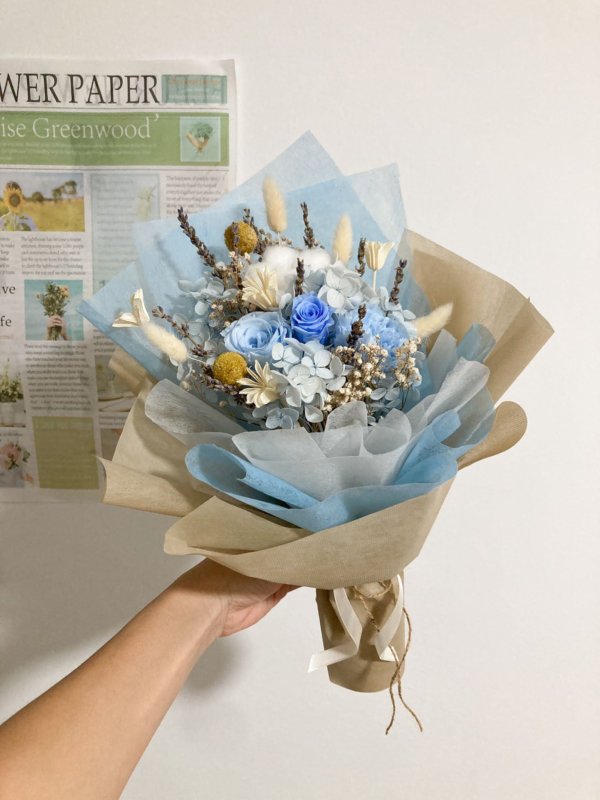 blue rose and carnation flower bouquet (wrapped in brown)